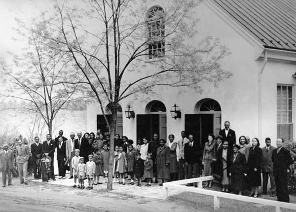 People Standing in Front of White Building