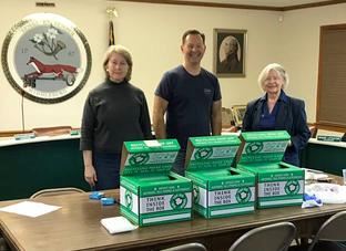 People Next to Battery Recycling Boxes